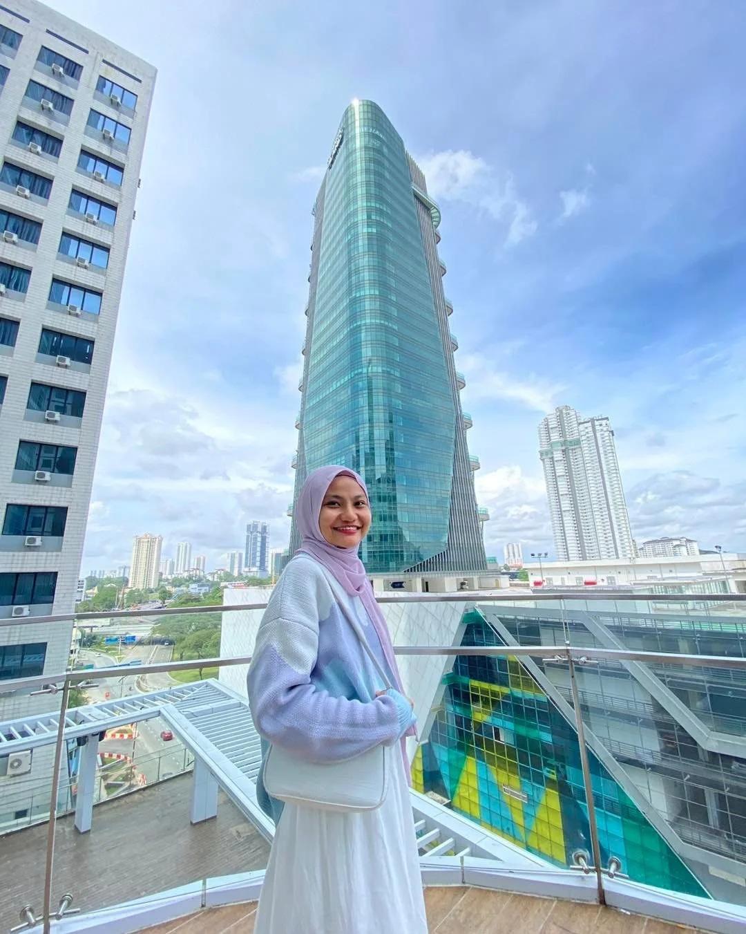 A woman standing on the balcony of the Amari Hotel in Johor Bahru