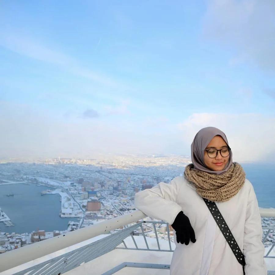A woman in a hijab at the top of Mount Hakodate