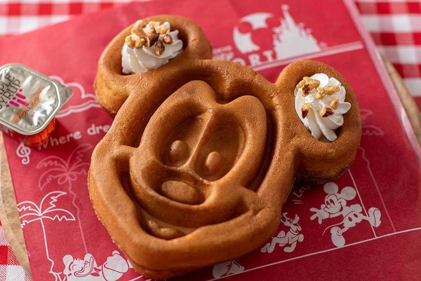 Mickey Mouse waffle with maple syrup and whipped cream